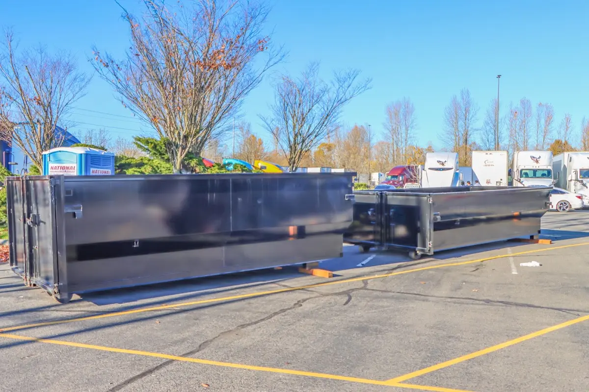 Professional dumpster rental service with roll-off container on residential driveway in St. Rose